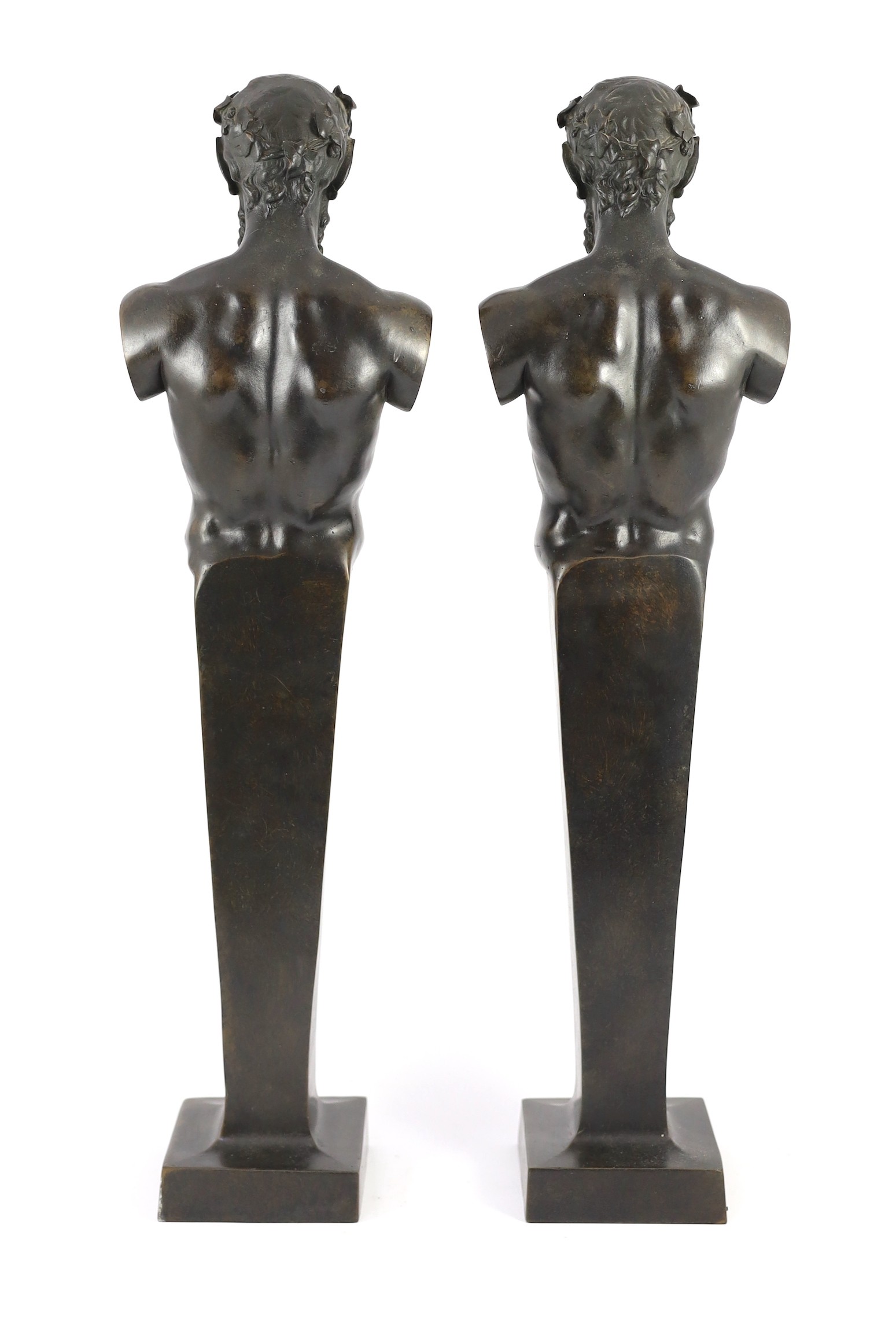 A pair of early 20th century French bronze terms, each in the form of a satyr, 16cm wide 62cm high